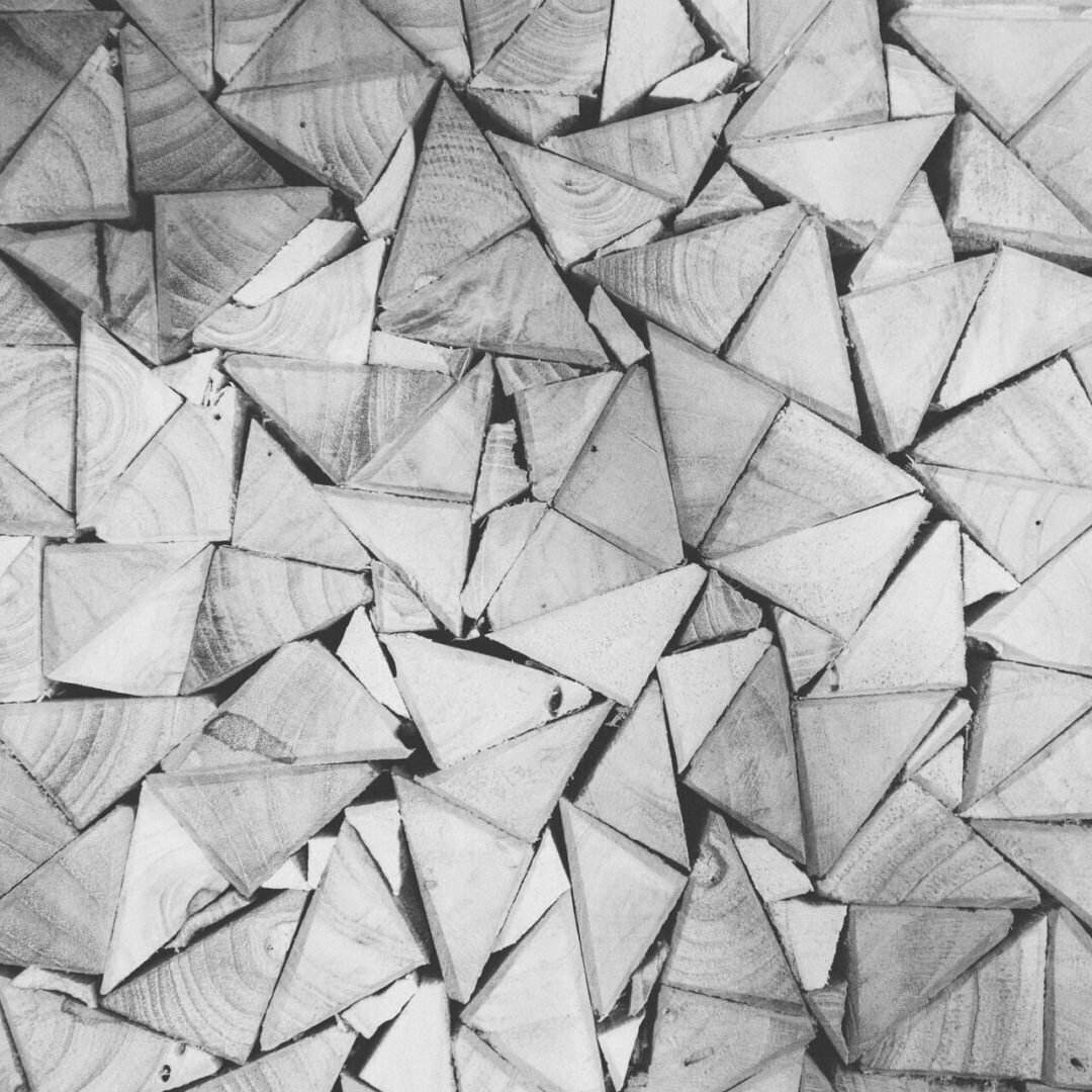 Stacked triangular wood pieces forming geometric pattern